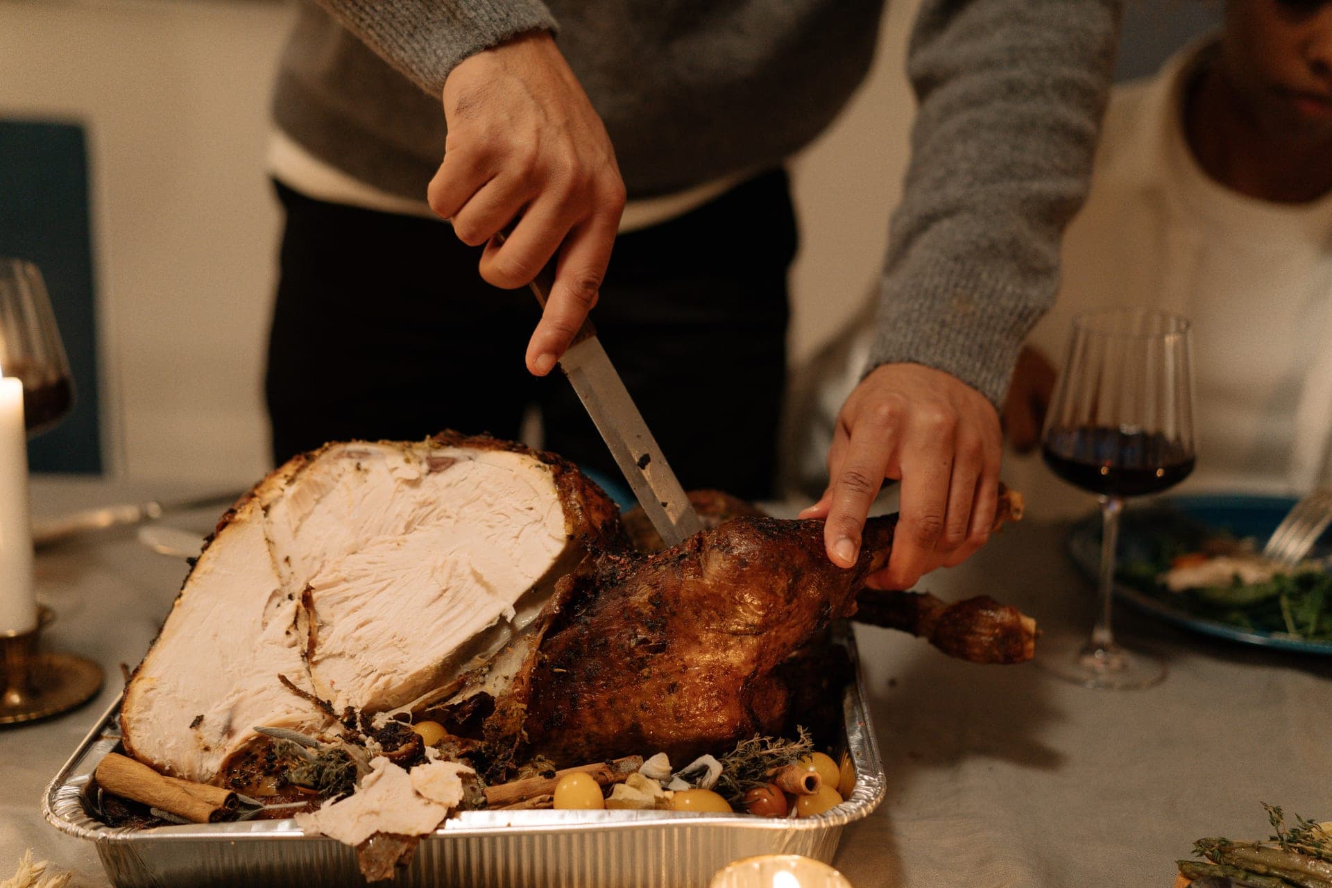 A roast turkey being carved at a holiday table