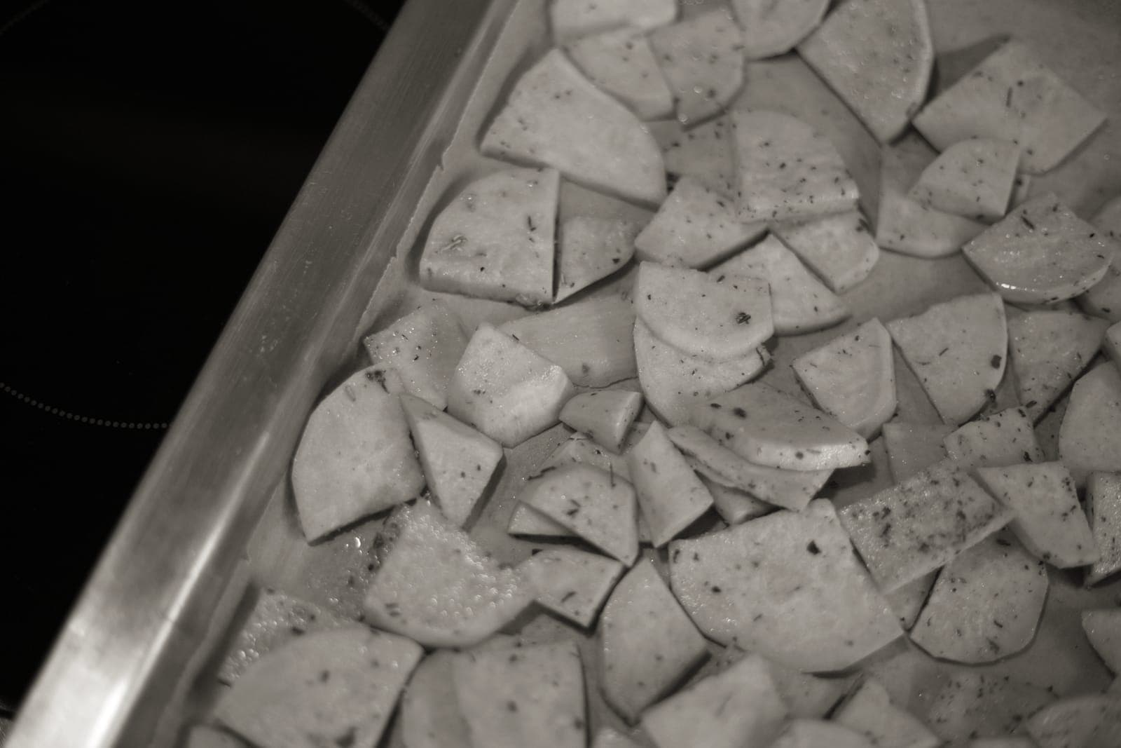 A deep roasting pan beside a flat rimmed sheet pan