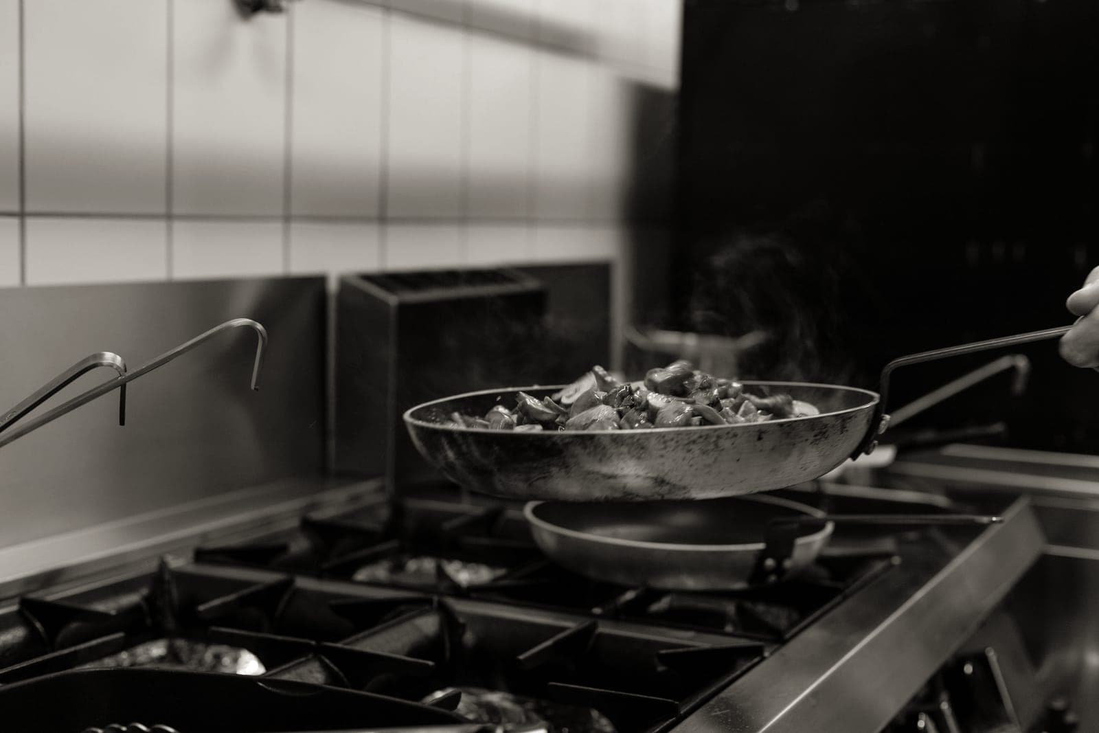 A dark, worn carbon steel frying pan