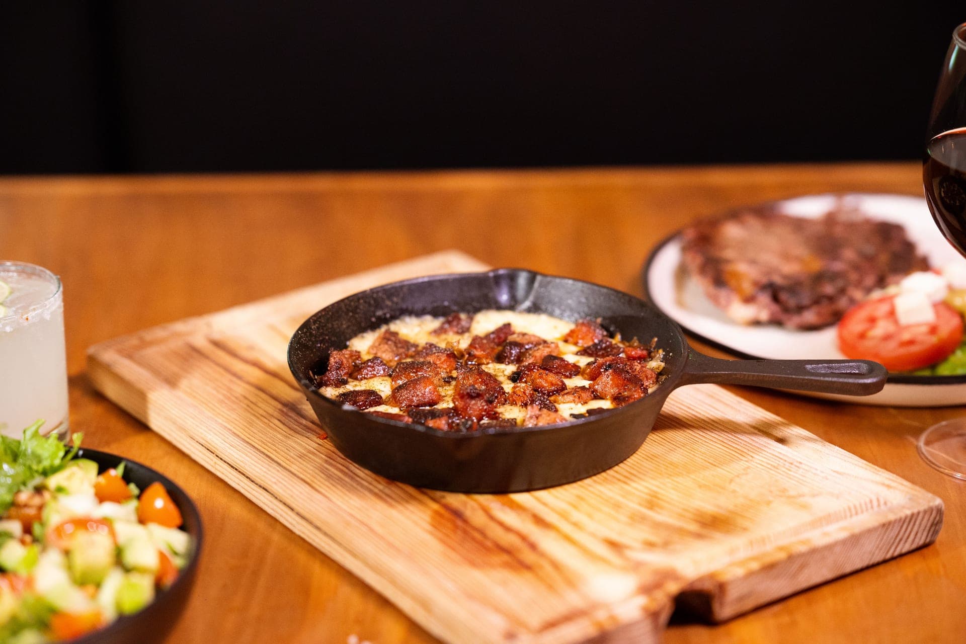 Food served in a cast iron skillet on a wooden table