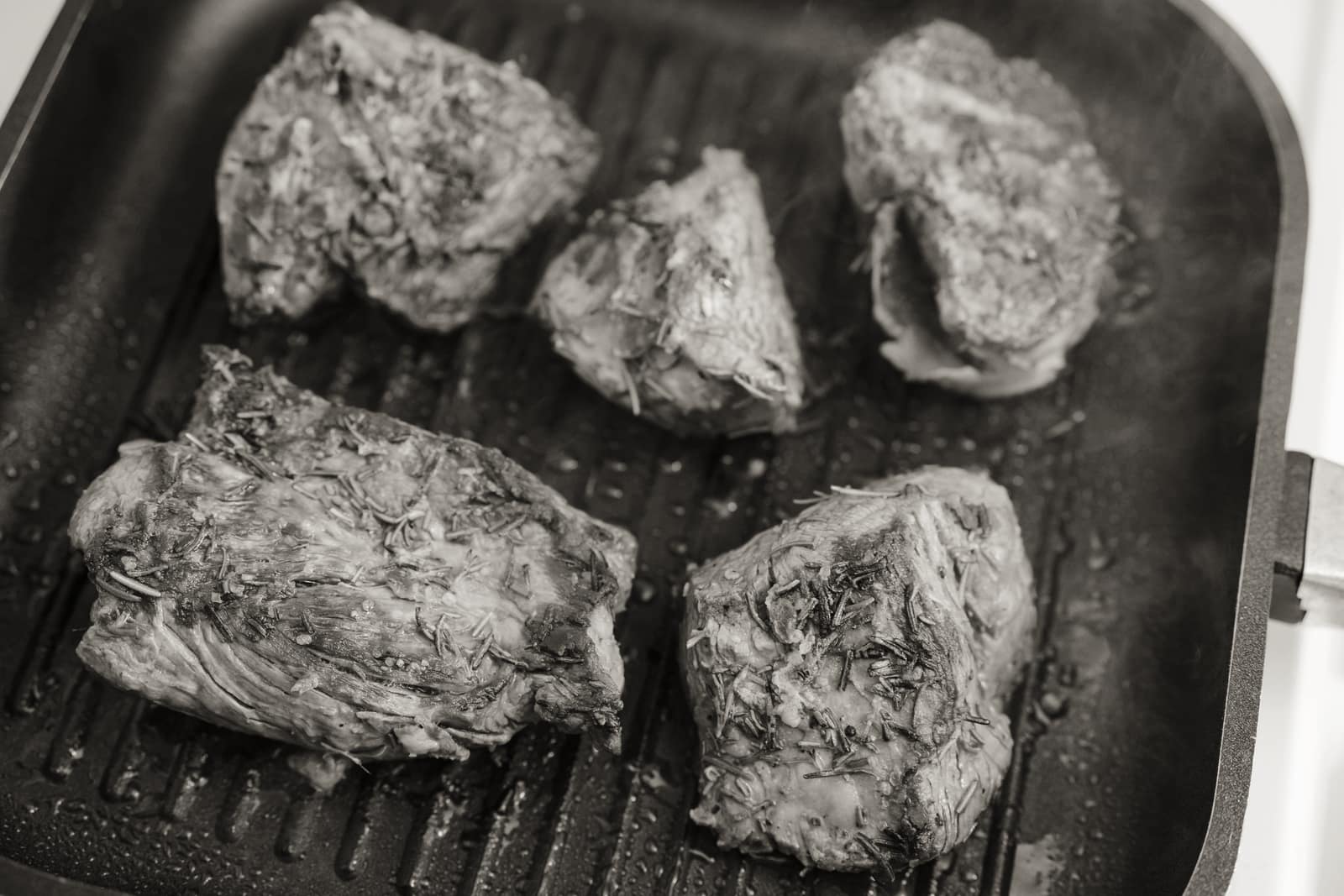 A ridged grill pan beside a flat cast iron griddle