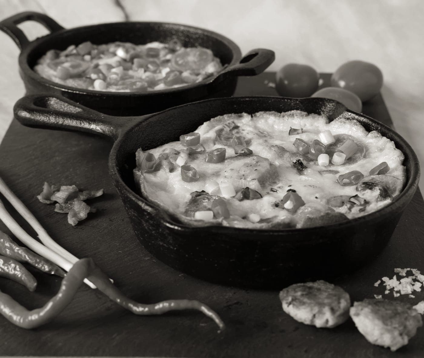 Two cast iron skillets of different sizes