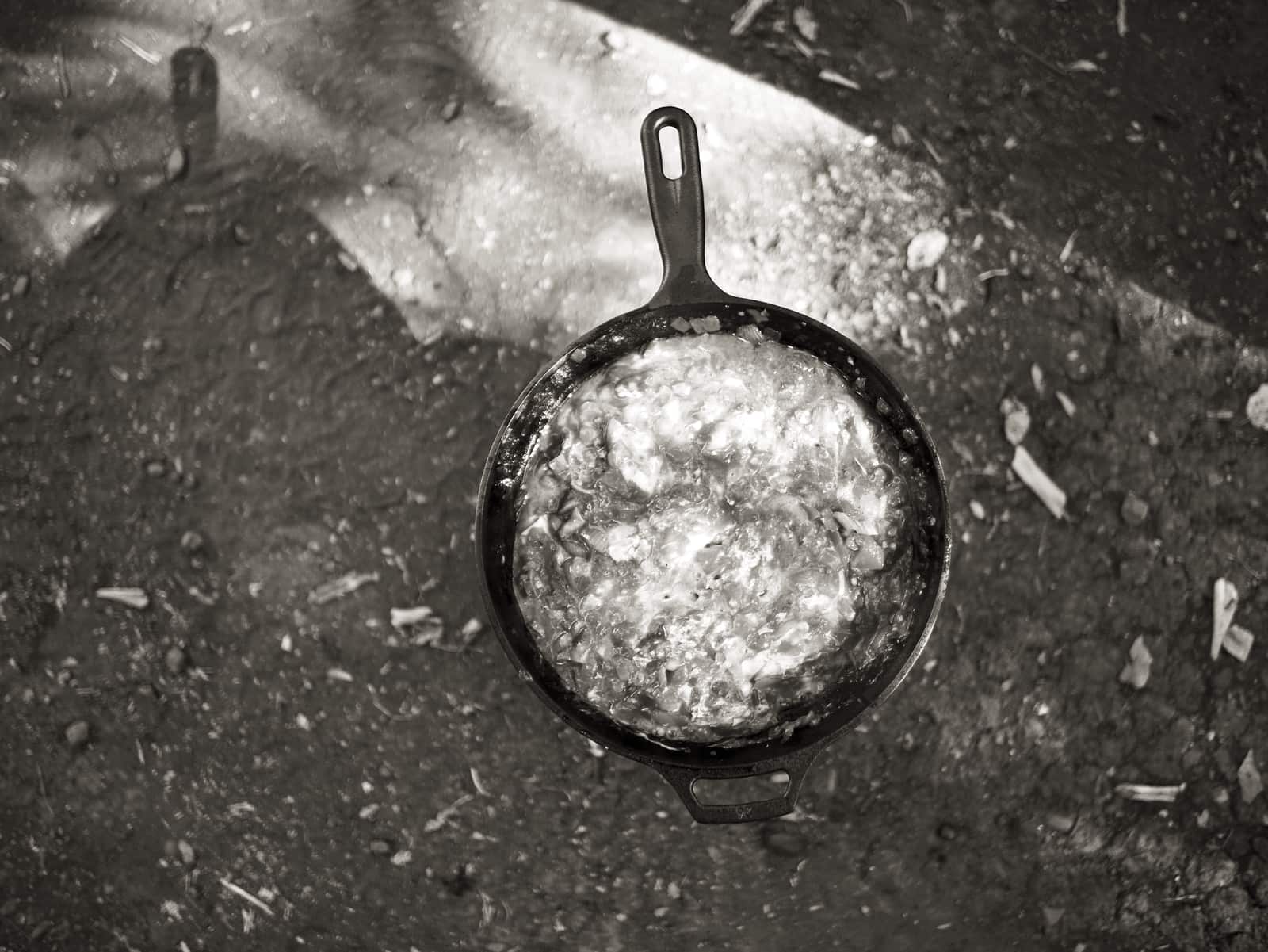 A cast iron skillet beside a heavy lidded pot
