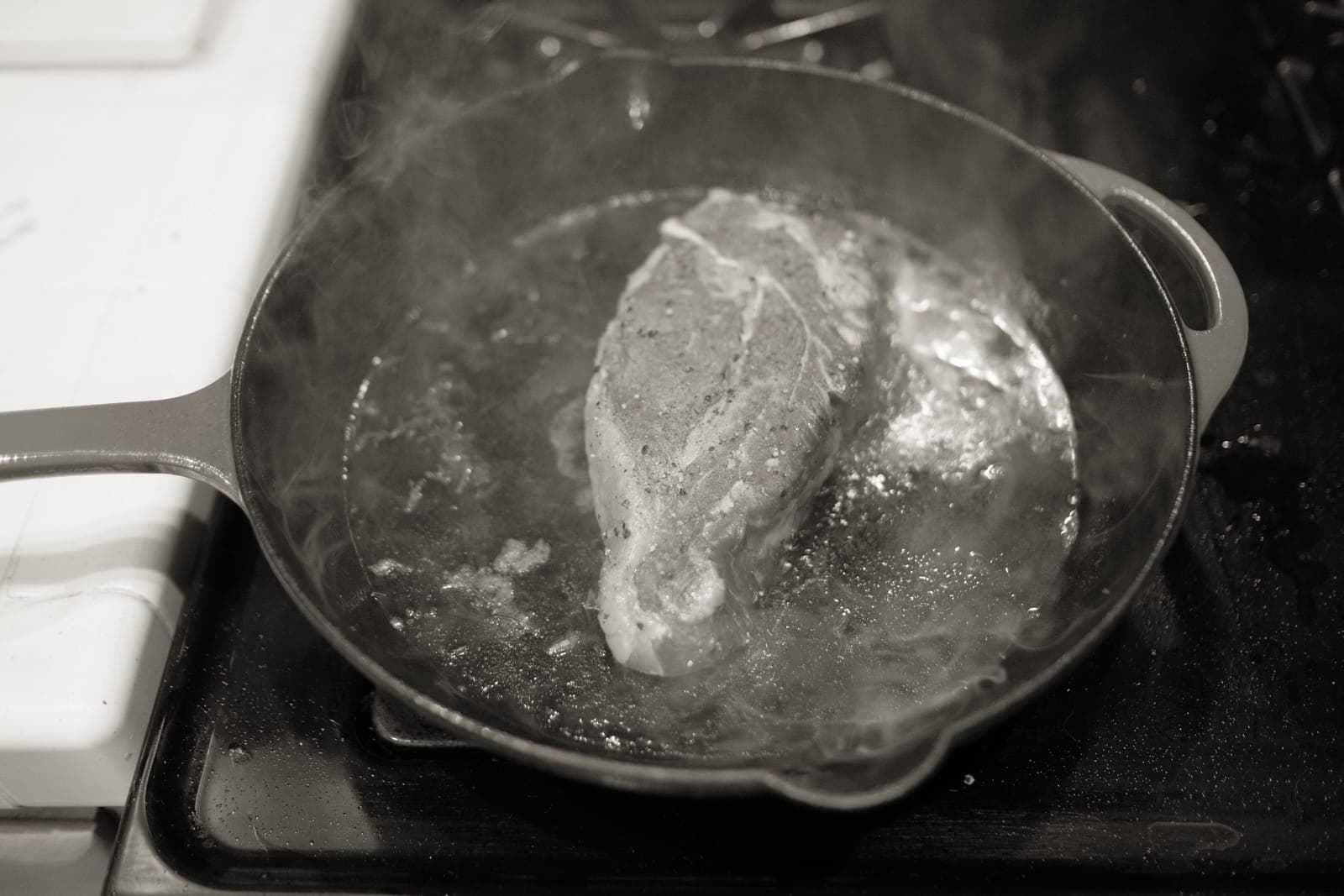 A cast iron skillet cooking on a stove