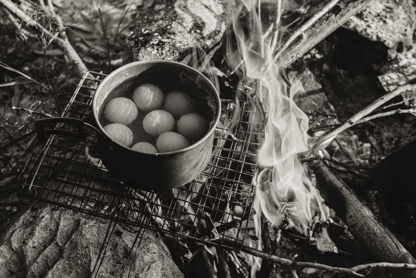 A pot cooking over a campfire