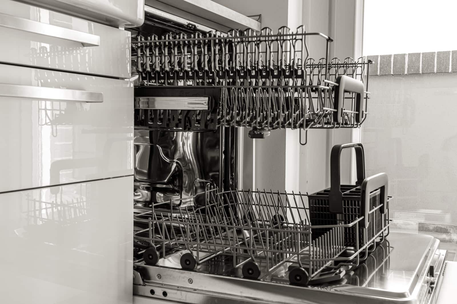 An open dishwasher rack loaded with dishes