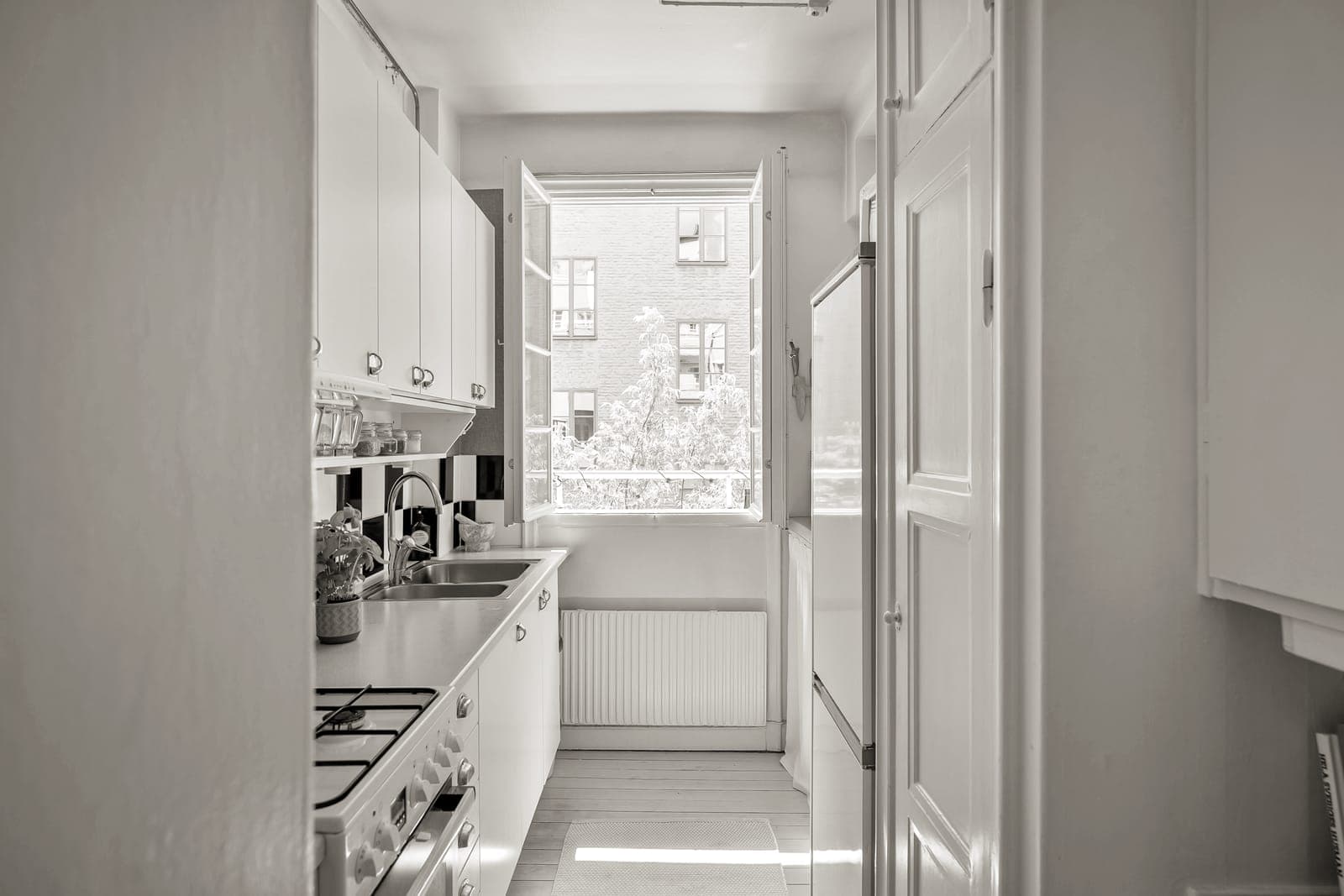 A small skillet and saucepan in a compact shared kitchen