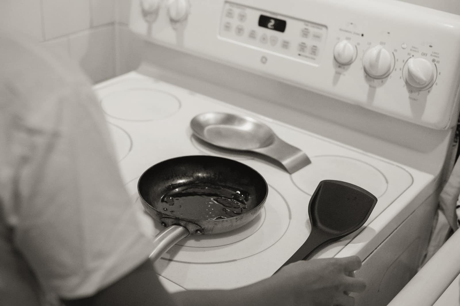 A pan heating on an electric coil stove top