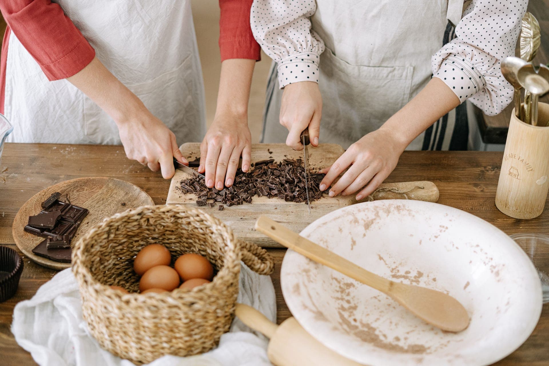 A wooden board, knife and baking ingredients on a kitchen table