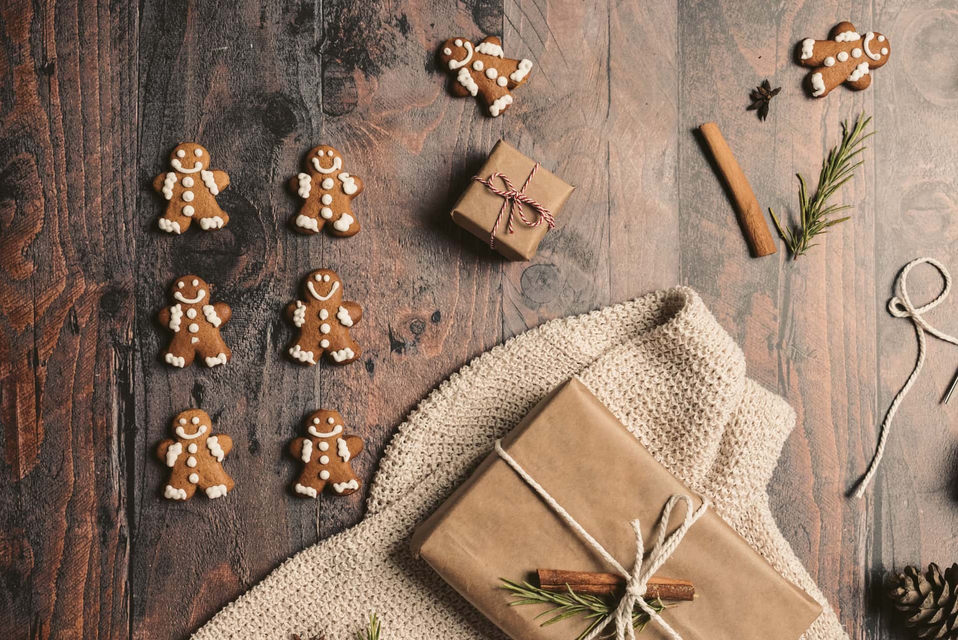 Wrapped gifts and baked goods on a wooden table