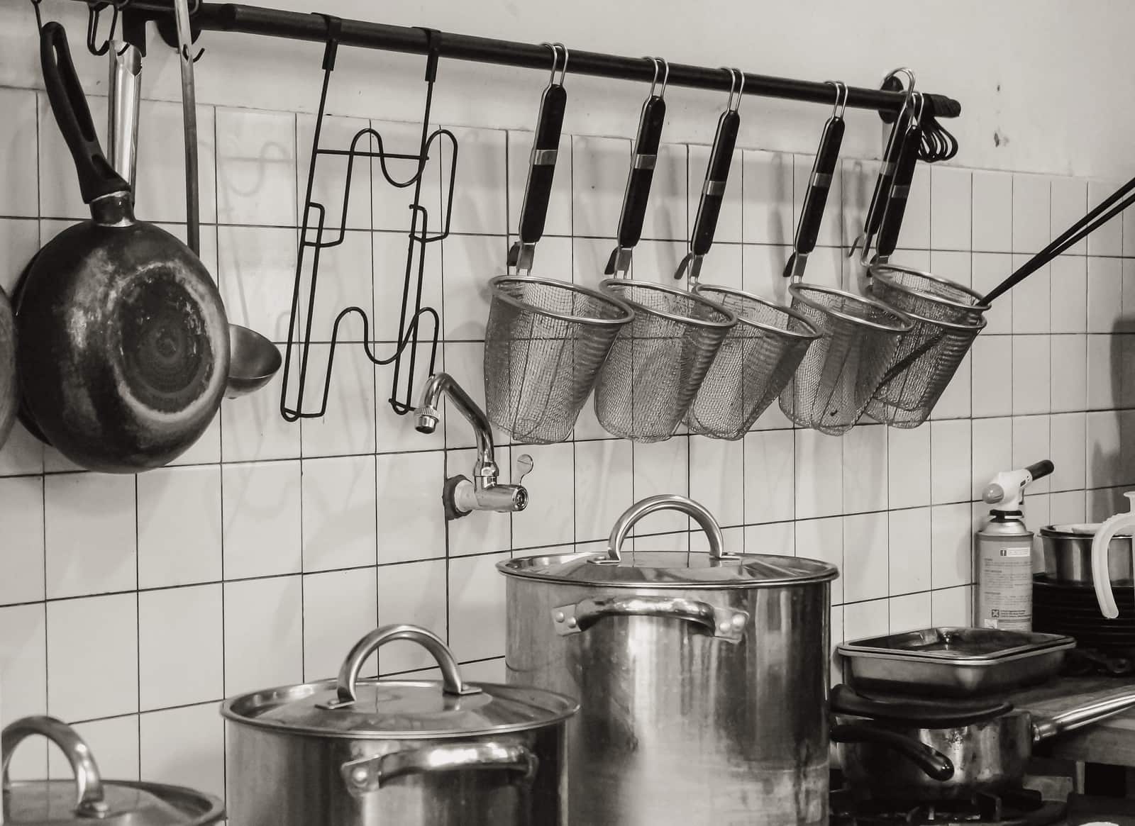Stainless, cast iron and ceramic pans arranged on a kitchen counter
