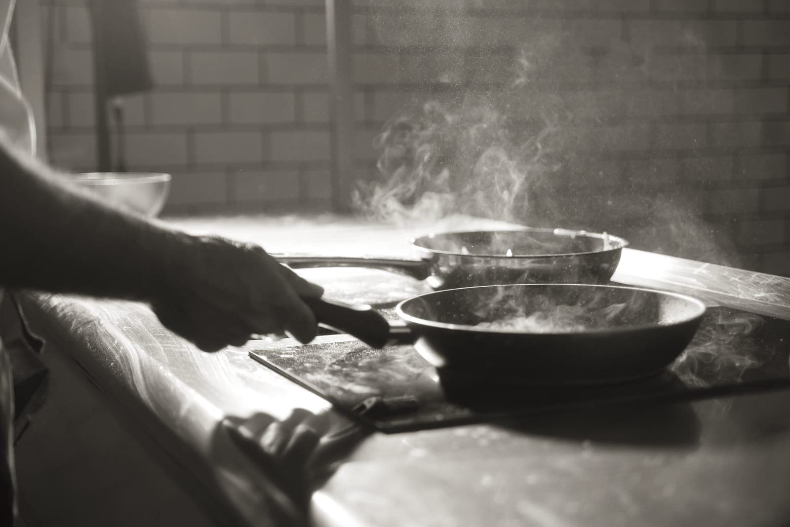A smoking hot frying pan on a stove