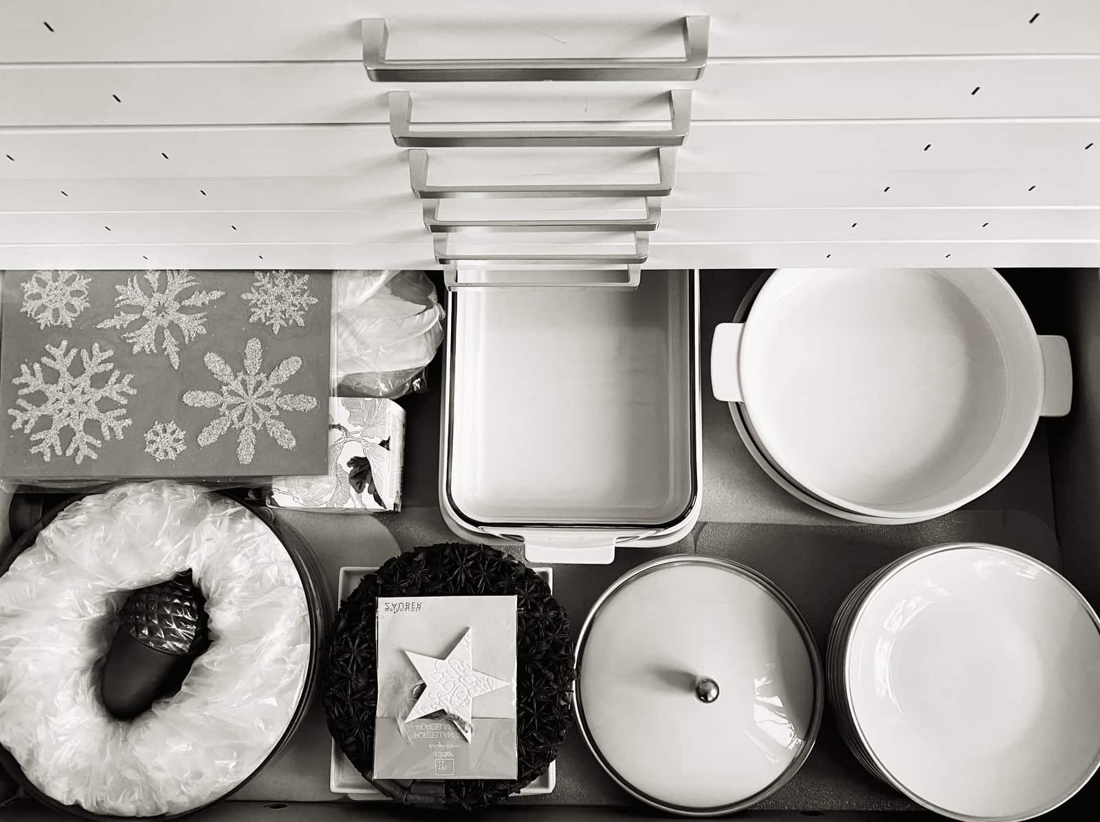An organized kitchen drawer holding cookware