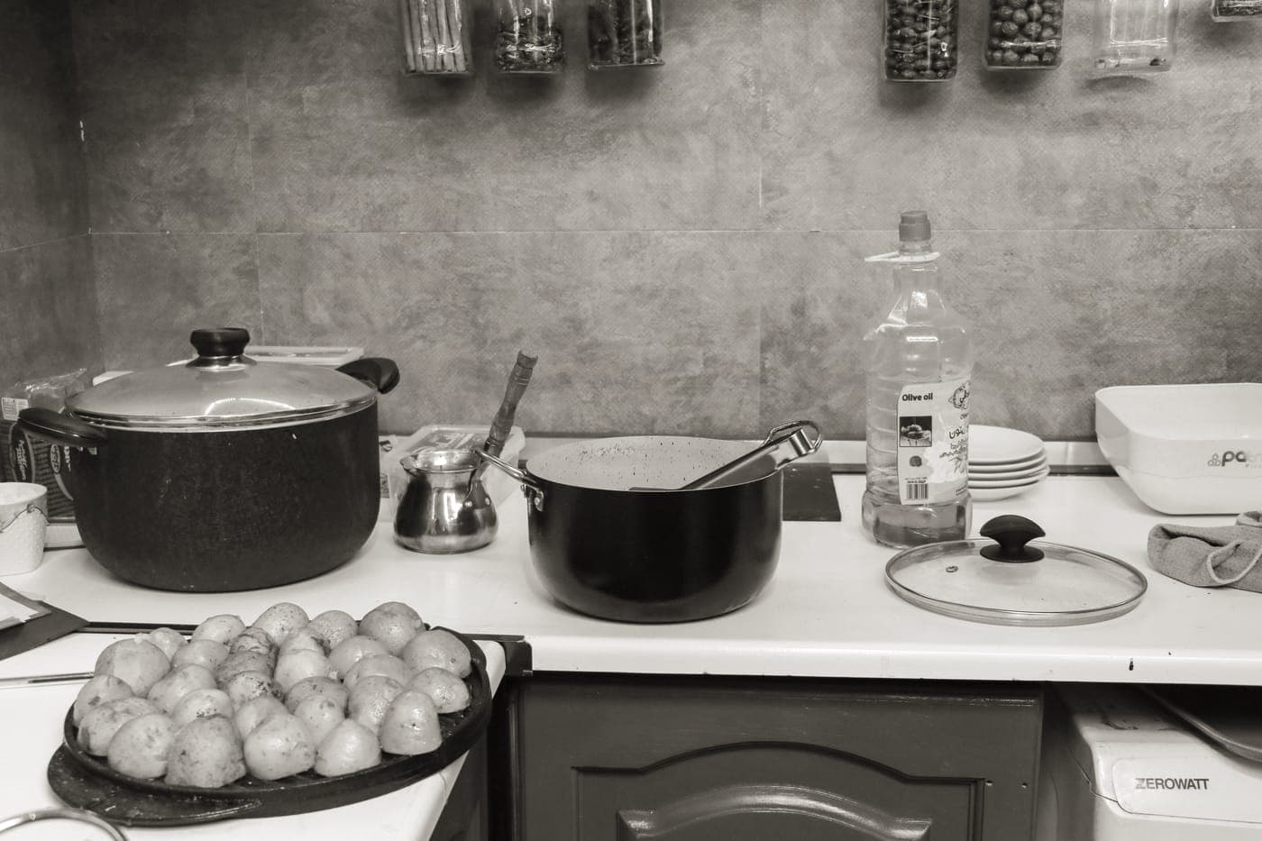 A small collection of essential pots and pans laid out on a table
