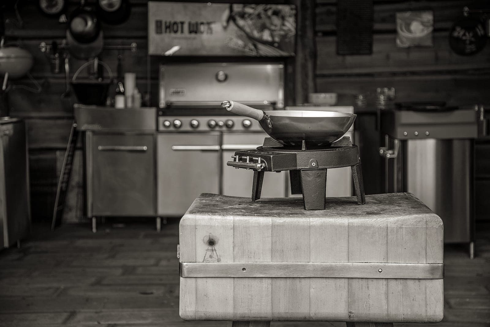 A carbon steel wok beside a skillet