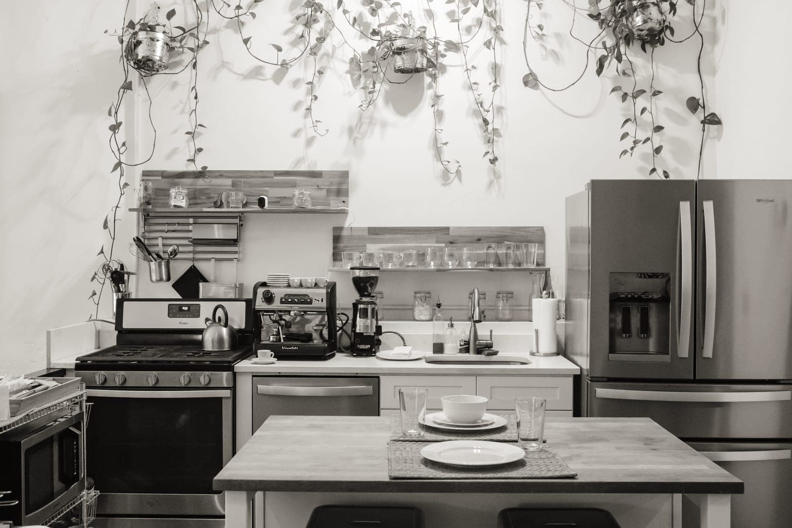 A kitchen counter part-way through being set up, with pans and a stack of plates