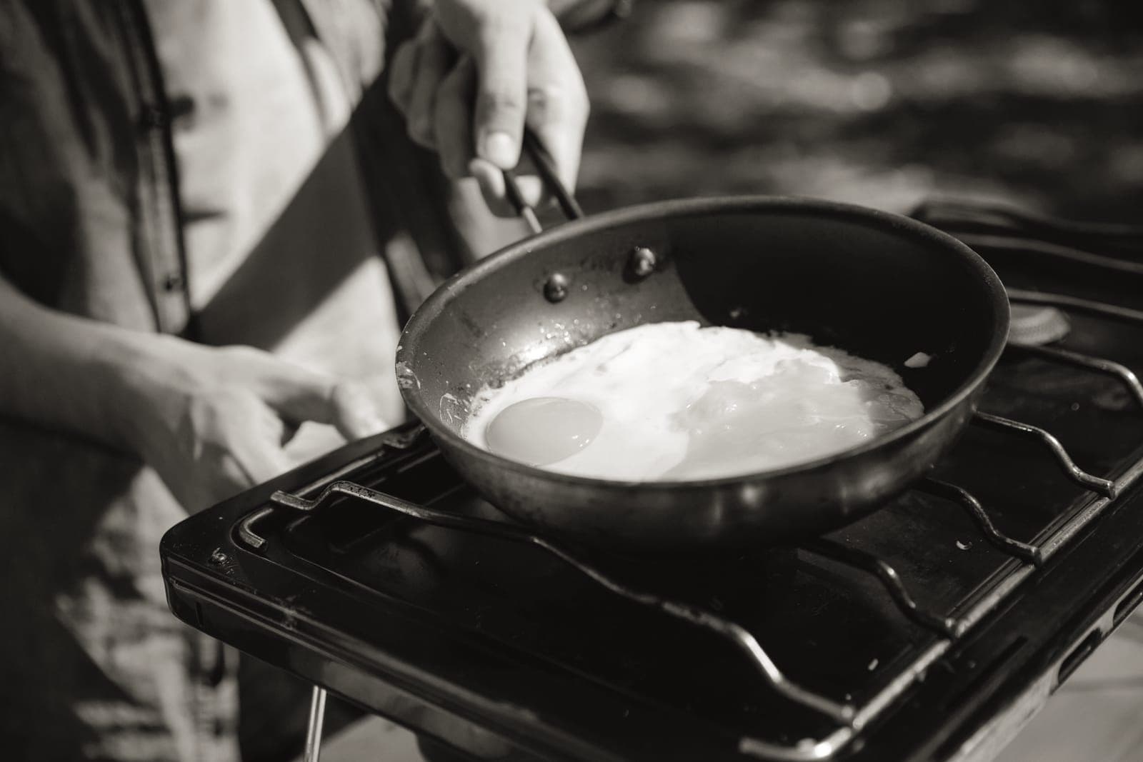 A ceramic-coated pan beside a stainless steel skillet
