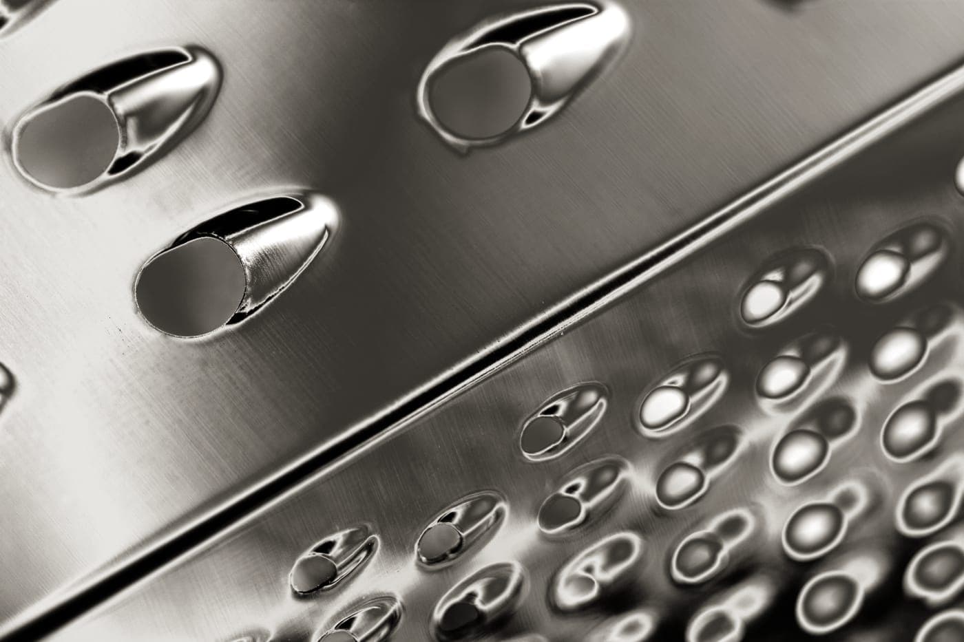 A gray metallic cookware surface photographed close up