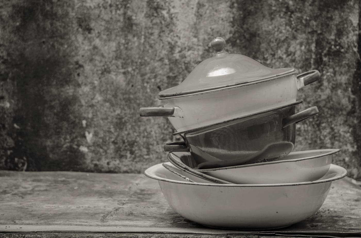 A stack of pot lids and pans