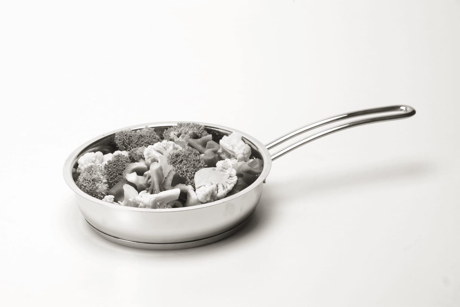 The underside of a stainless steel pan