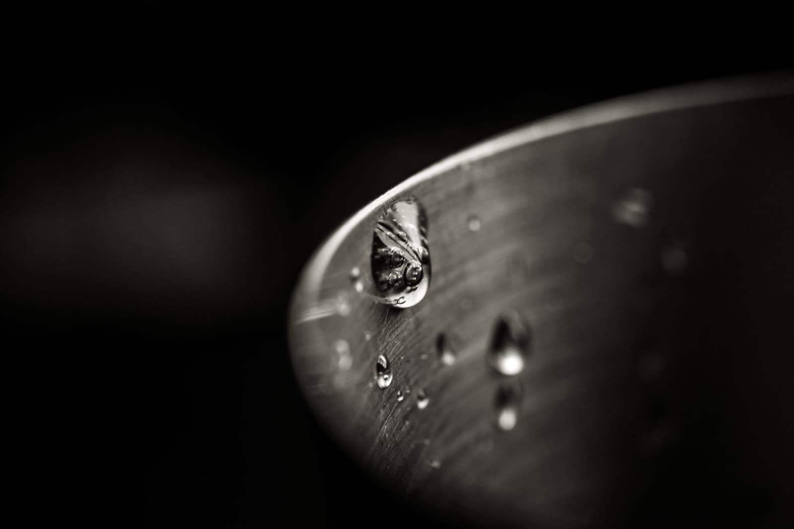 The cut edge of a stainless steel pan showing bonded layers