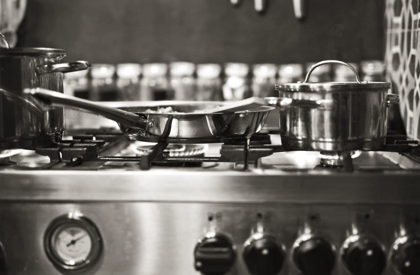 A stainless steel pan heating on a hob