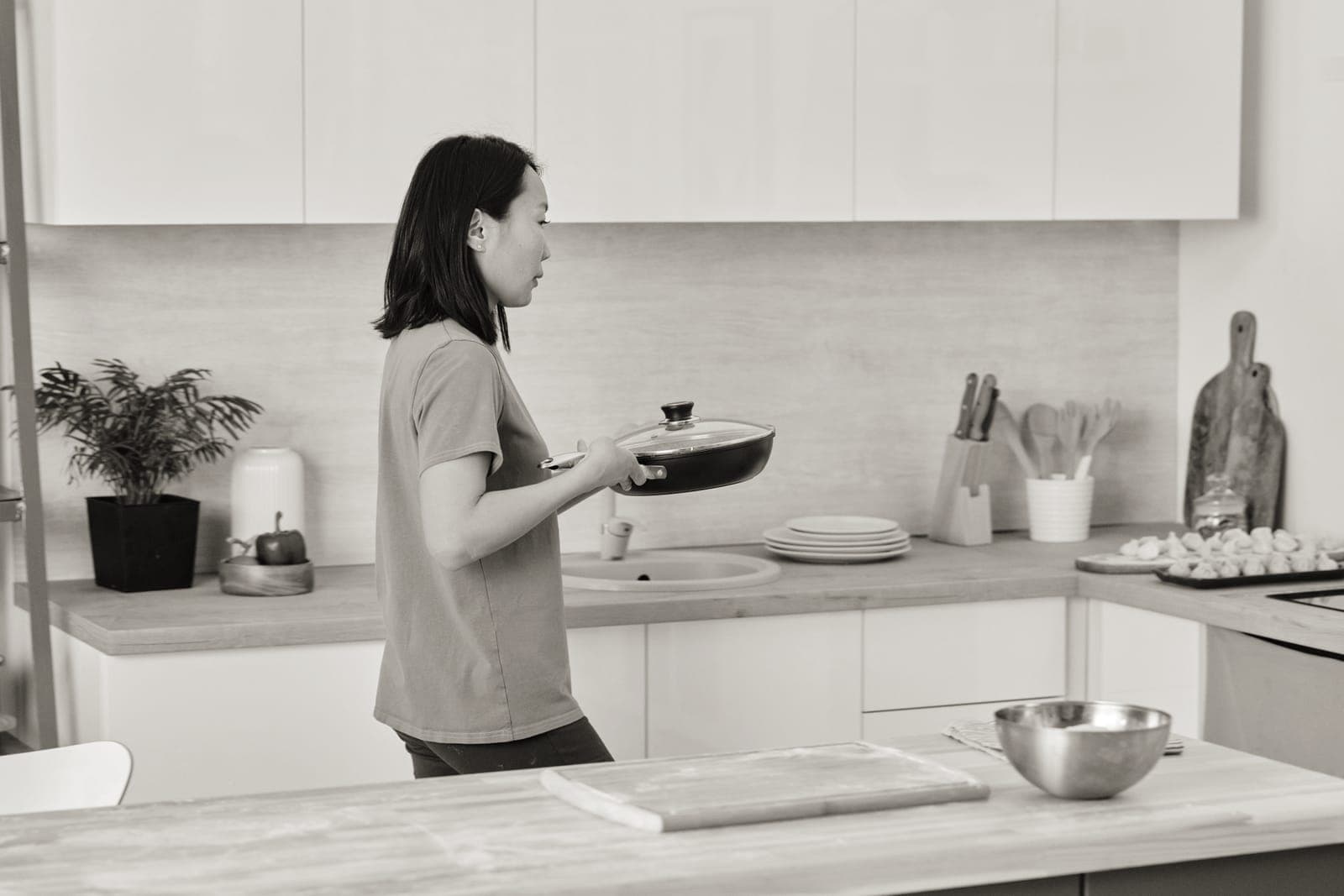A stainless pan and an aluminum baking sheet on a counter