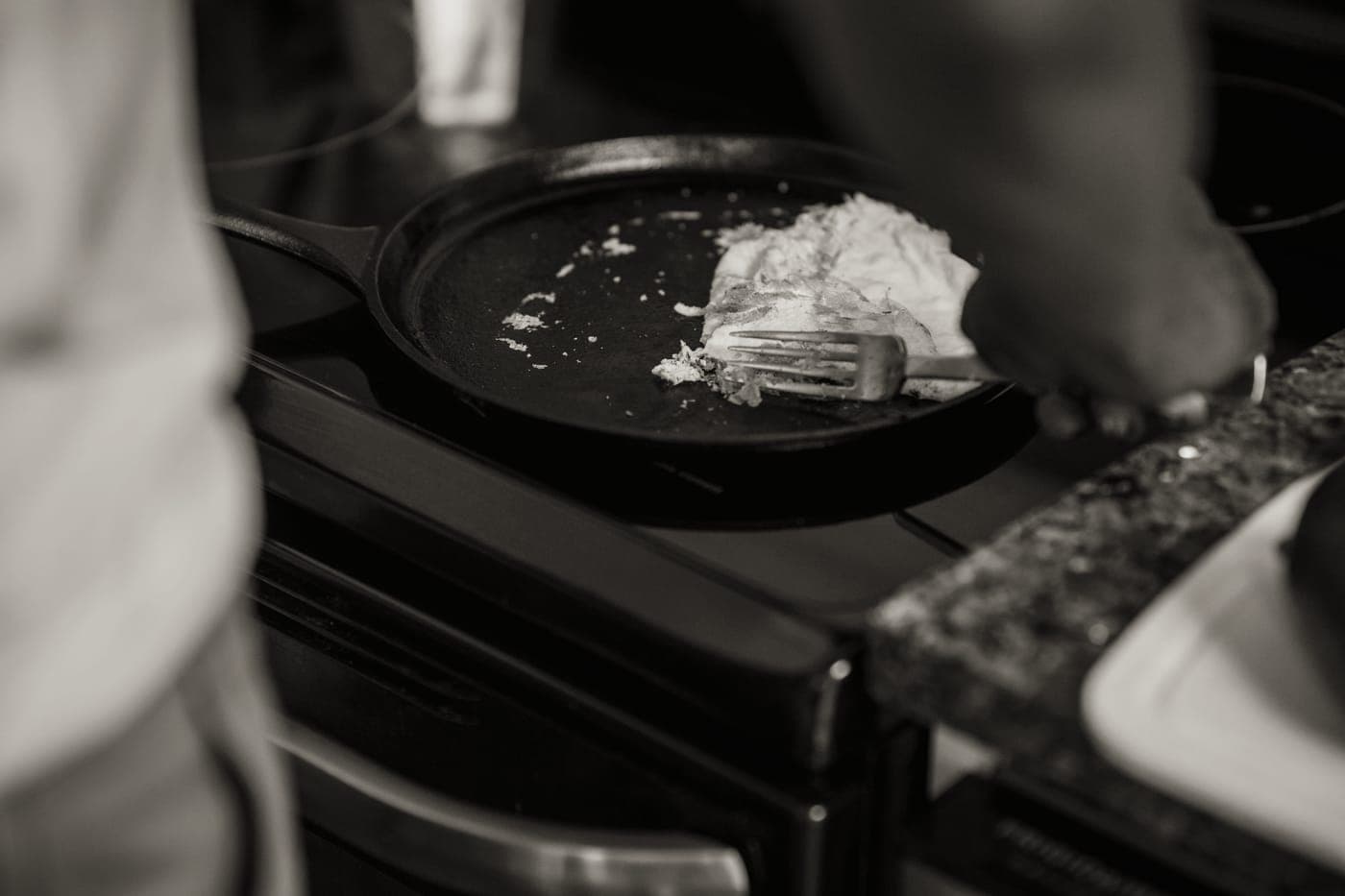 A cast iron skillet and a stainless steel pan side by side
