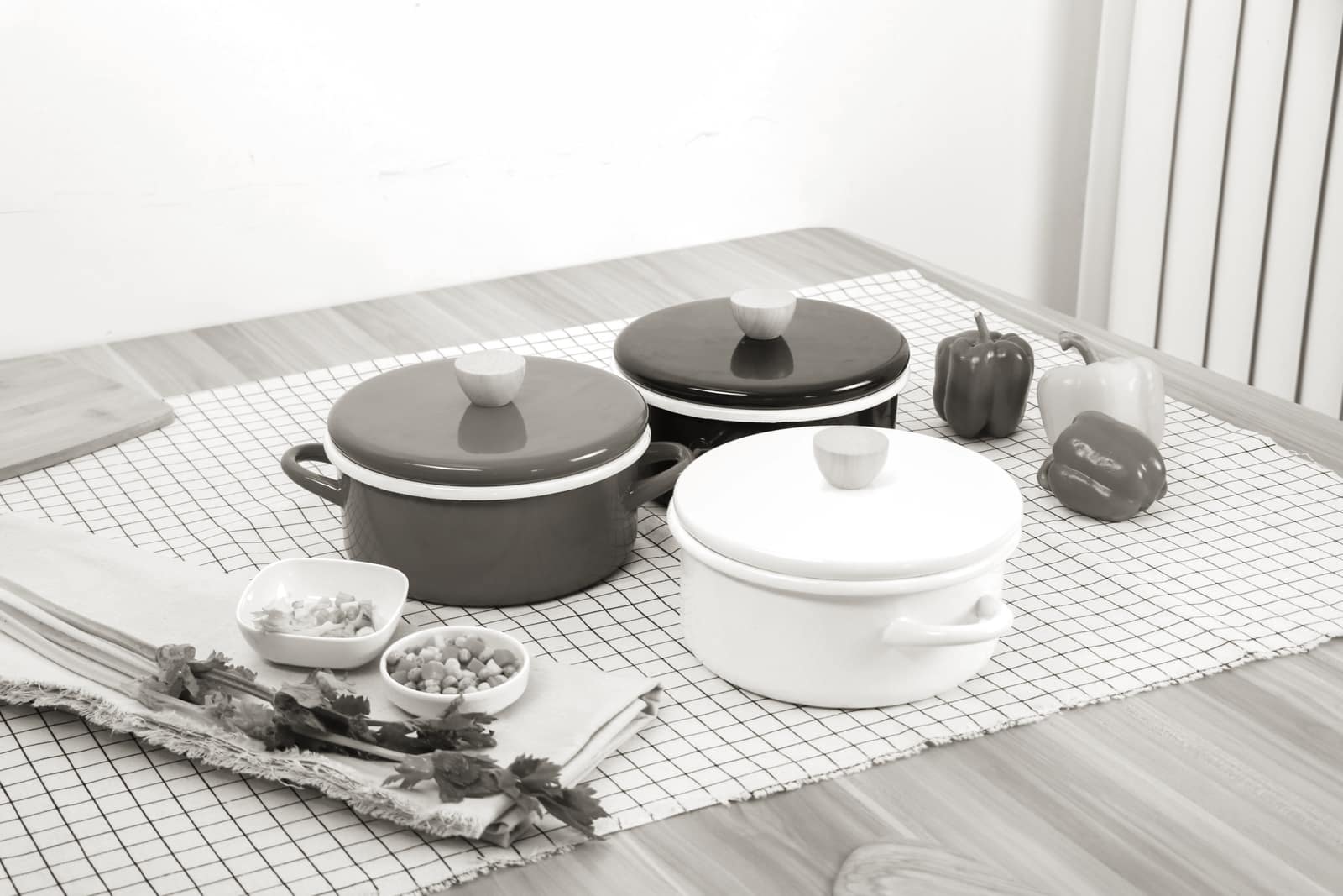 A steel pot beside an enameled pot