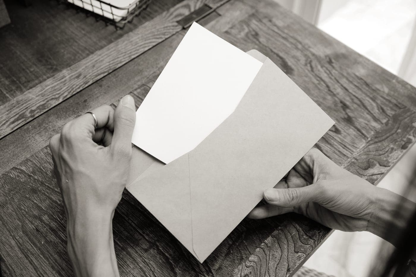 A letter and an envelope on a wooden desk