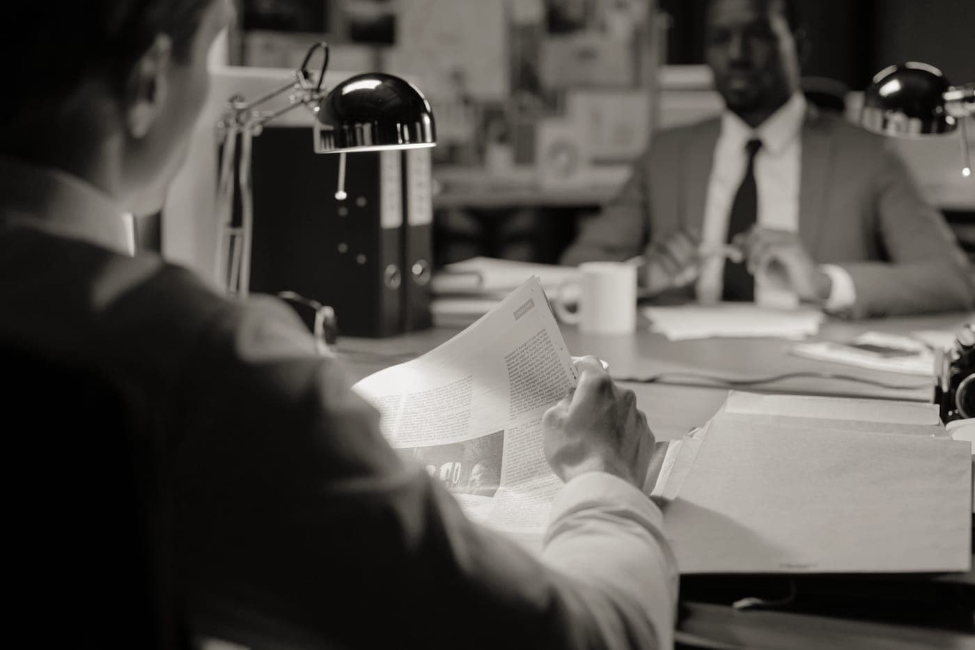 Someone reading a printed document at a desk