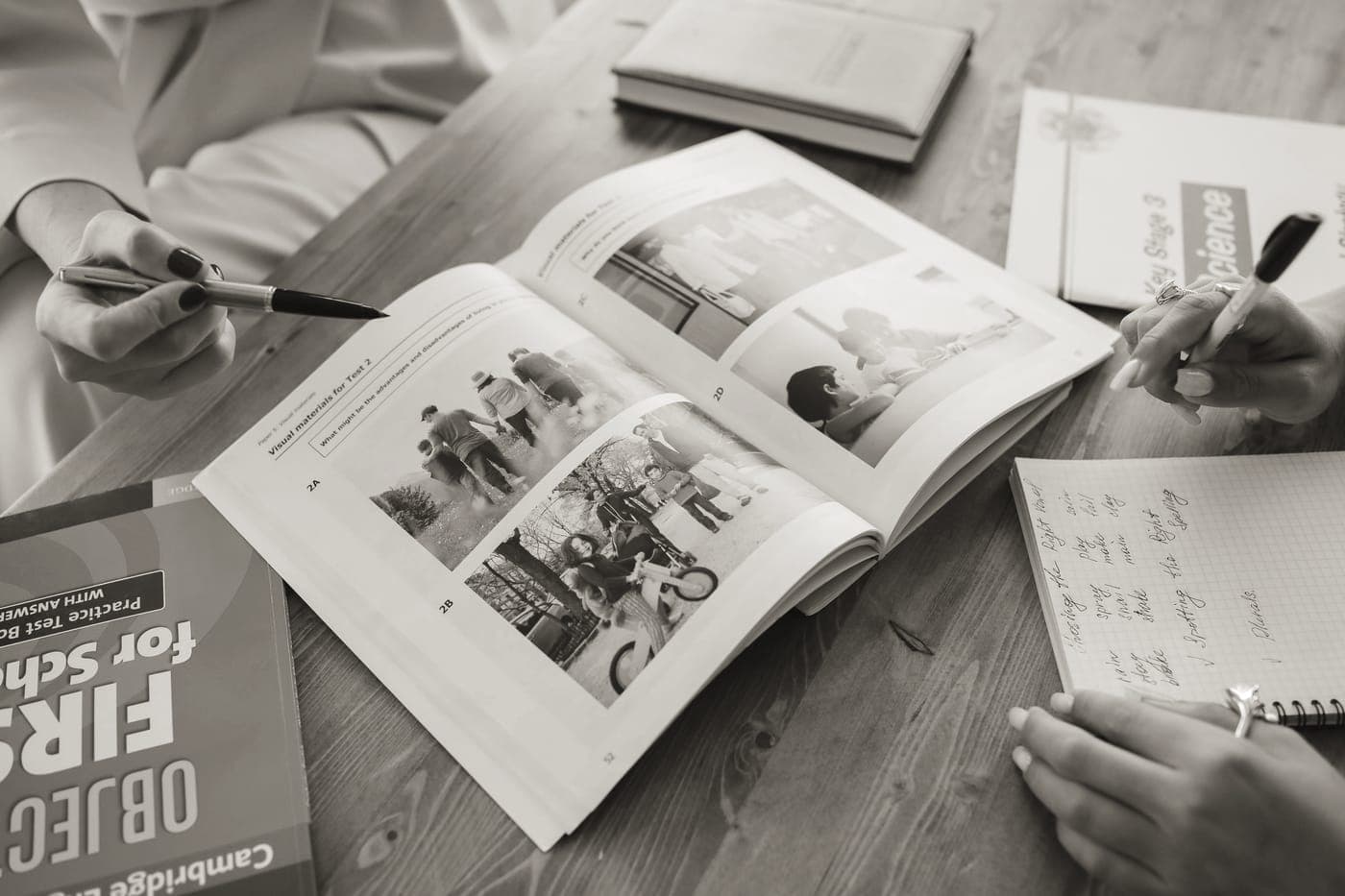 An open product manual and a notebook on a kitchen table